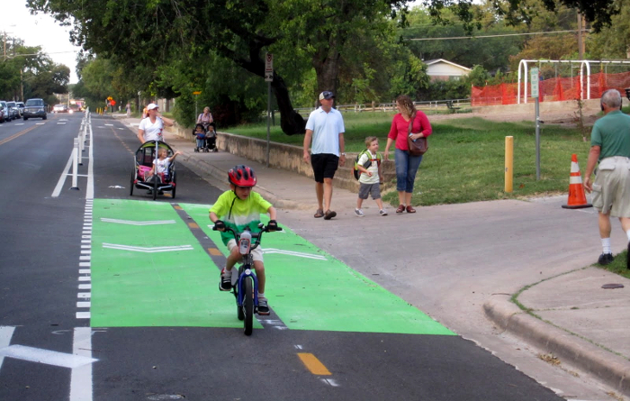 A child cycling safely in Austin, Texas