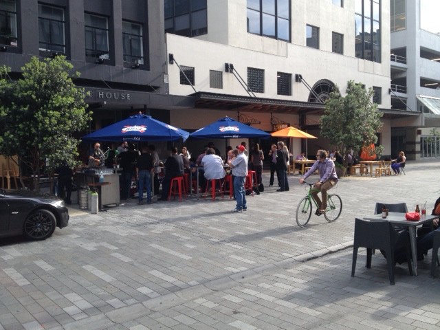 People enjoying themselves in the new Eastern end of the shared space - cars are second place