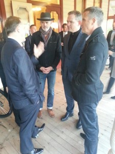The PM chats with Patrick Reynolds, Ernst from NZTA, and Bruce Copeland.