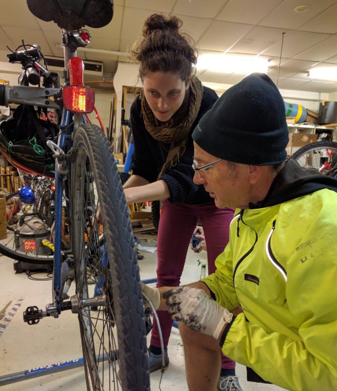 What do-it-with-others looks like: Tumeke volunteer Sanna Moeller helps a customer sort out his rear derailleur.
