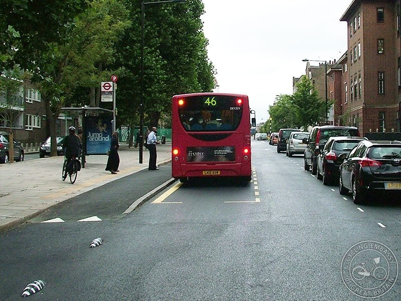 This is comparable to the other stops, where the cycle lane will ramp up to a bus stop platform, and people on bikes will have to stop (or go around, like the lady on her bike to the left, but giving way will be the key here).