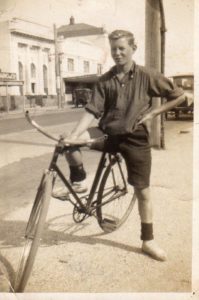 George Bell on a bike at the Pt Chevalier shops, 1931 (Photo: Keith Bell, George's son – as seen on Timespanner and shared with permission)