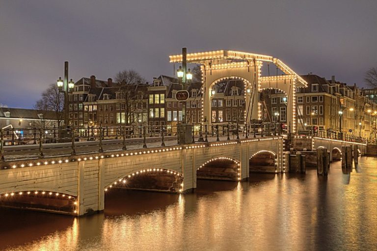 Magere Brug in Amsterdam lit up brightly at night