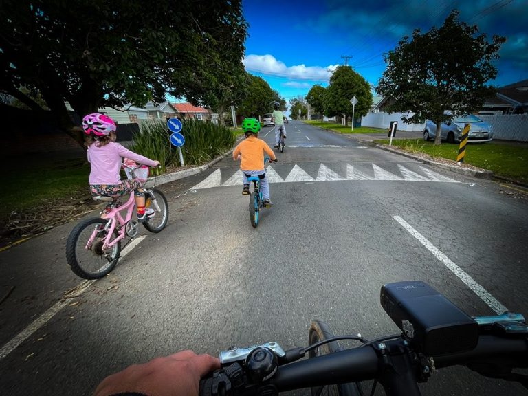Kids riding their bikes on a quiet road