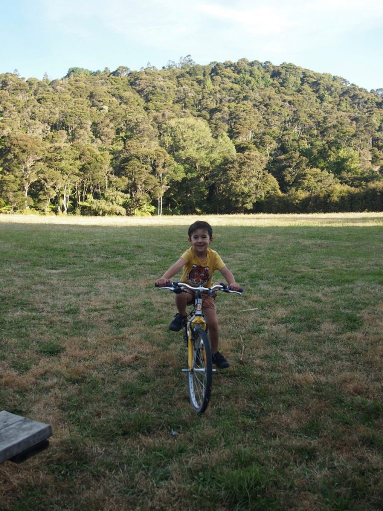Child riding a bike in a campground