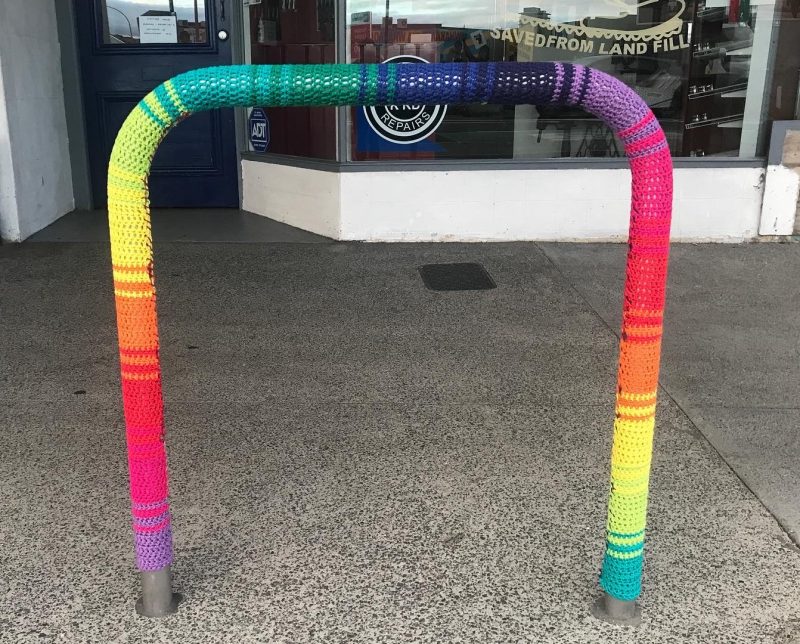 A bike park covered with rainbow yarn