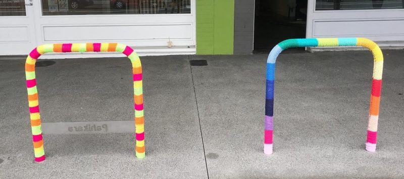 Two decorated bike parks, one in highlighter colours.