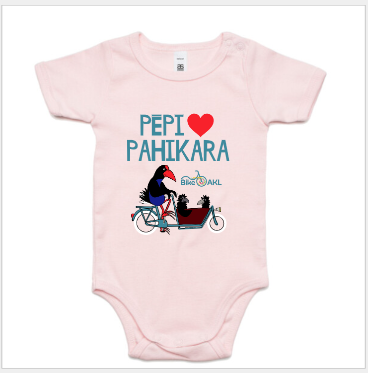 A baby onesie that says "pēpi heart pahikara"