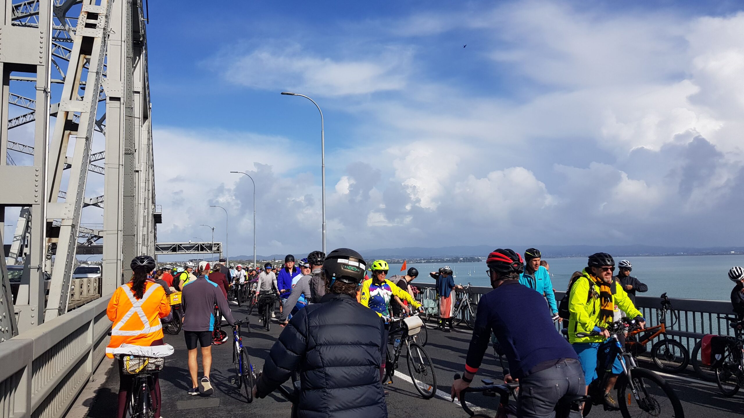 The bridge is crowded with people riding bikes over it as part of a demonstration