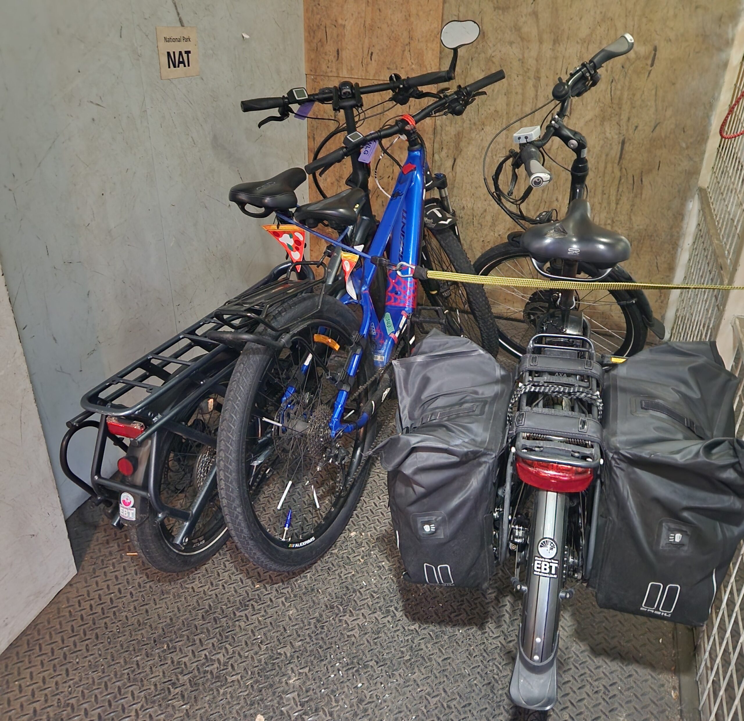Three bikes strapped in to a small compartment