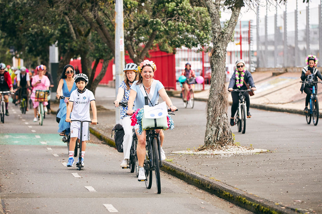 Smiling colourful people bike outside Ports of Auckland