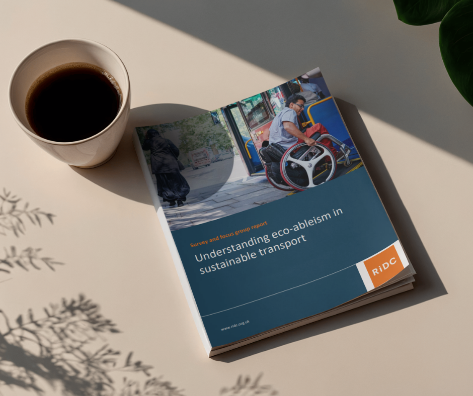 Eco-ableism report sits on a table next to a coffee