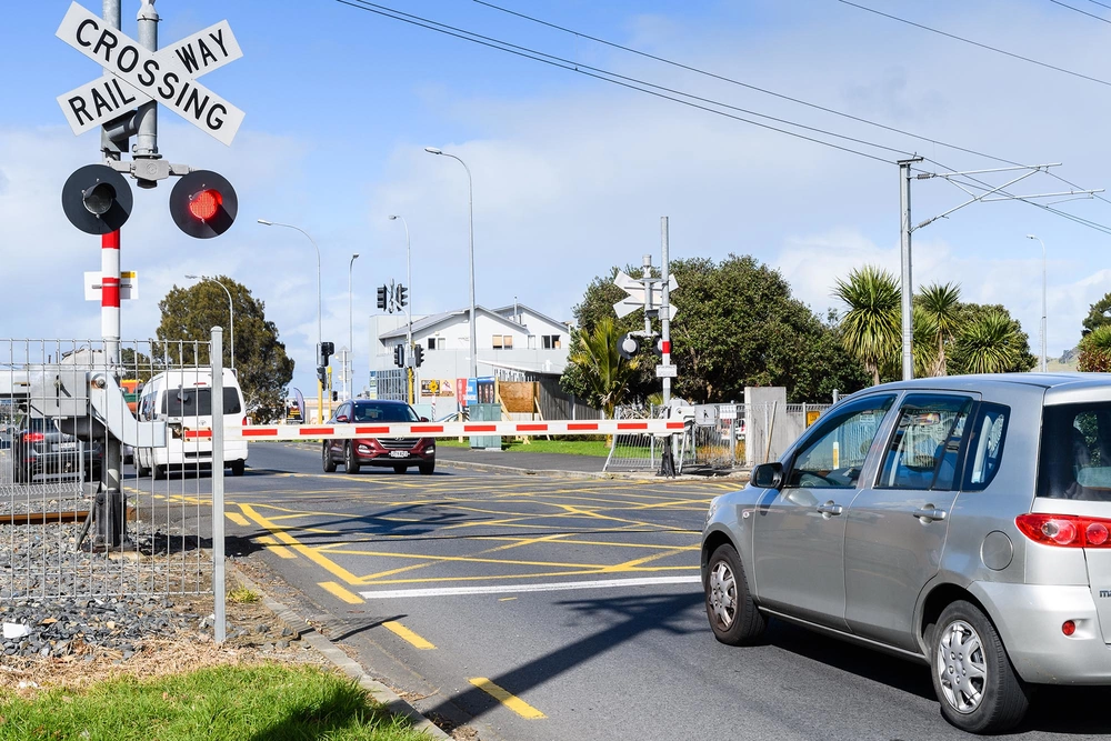 car waits at level crossing