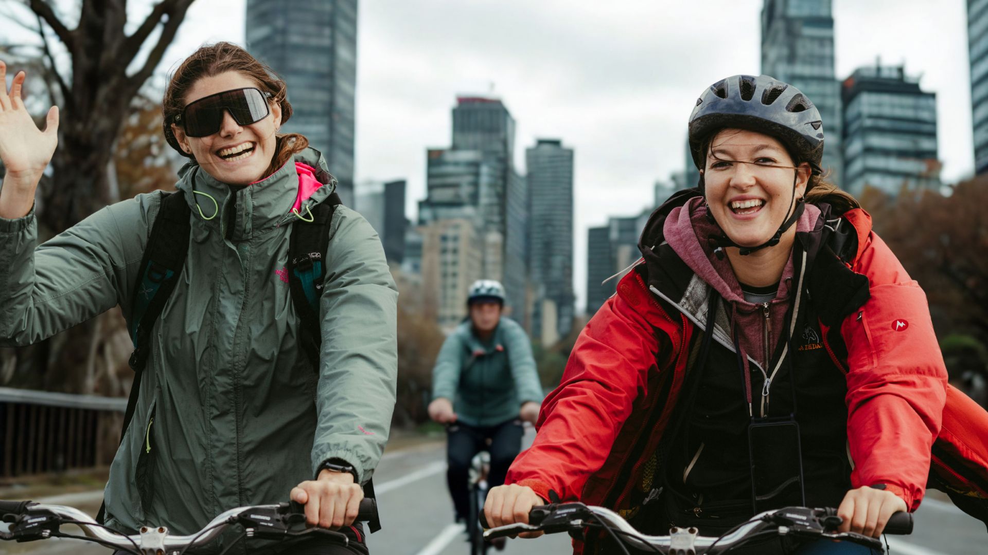 woman waving from a bike
