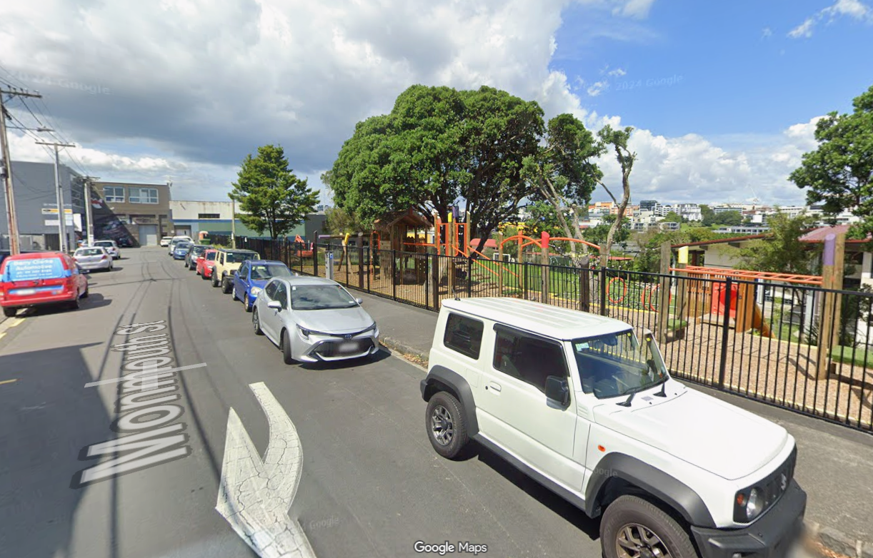 streetview image of a carlined street outside a school playground